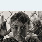 boy looking through fence accidental childhood exposure to porn - Cole's story